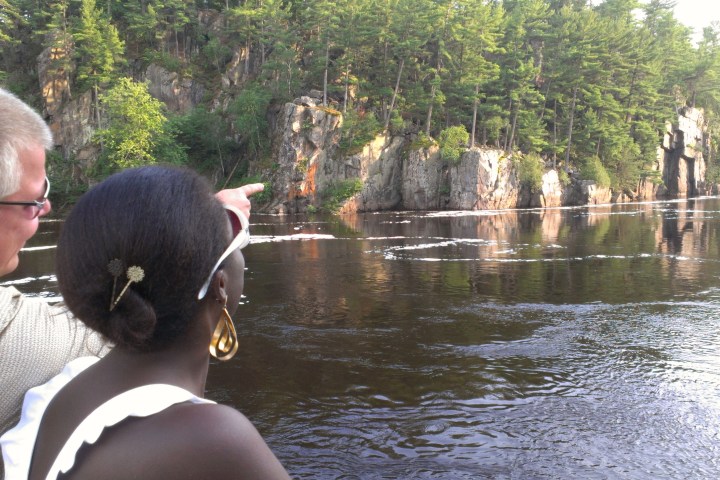 a man standing next to a river