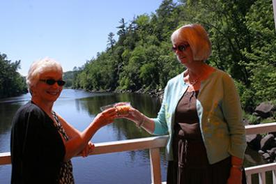 a man and a woman standing in front of a body of water
