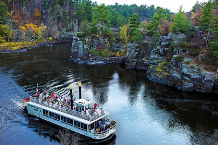 a boat traveling along a river next to a body of water