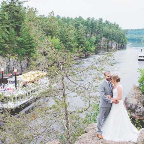 a person standing on a bridge over a river