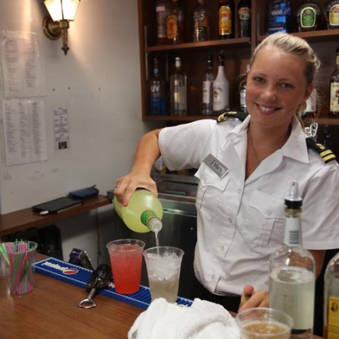 a person sitting at a table with a bottle of wine