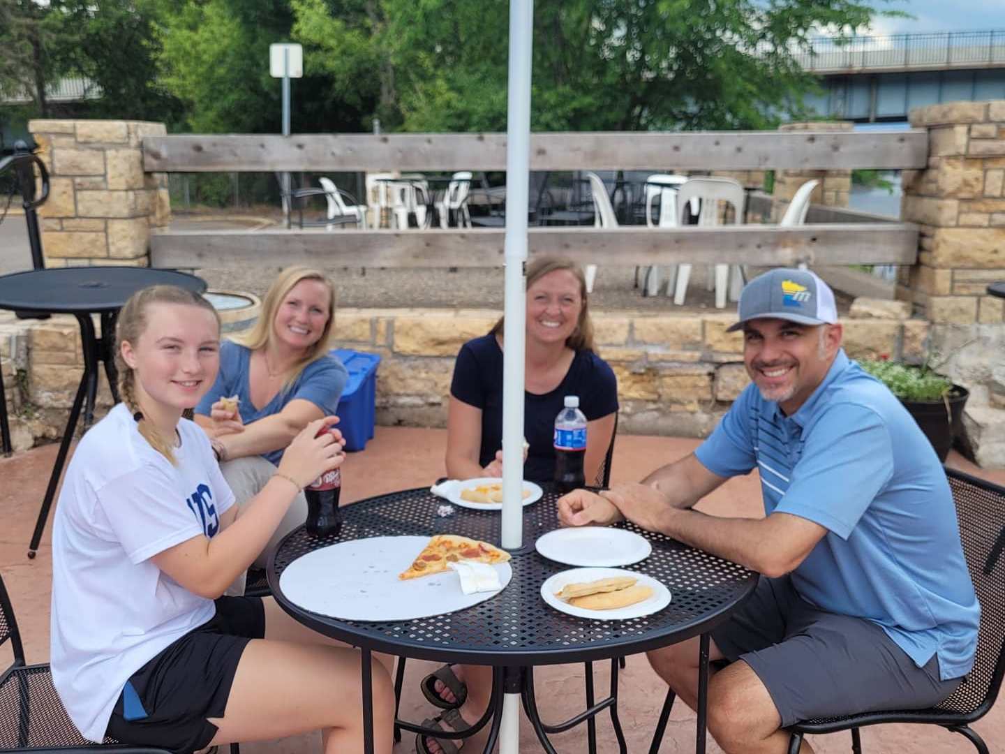 a group of people sitting at a picnic table