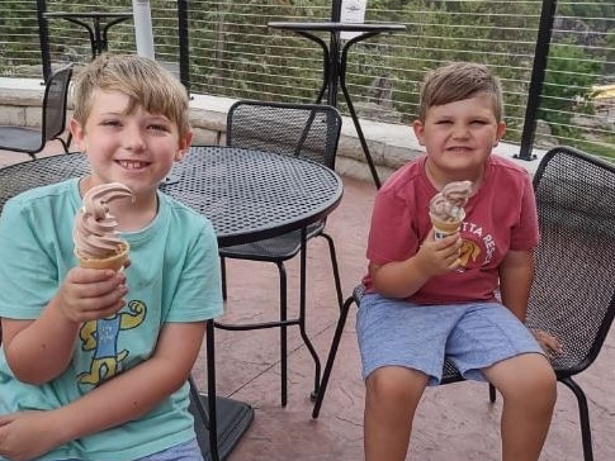 a little boy sitting on a bench posing for the camera