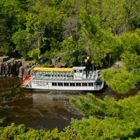 a boat traveling along a river next to a body of water
