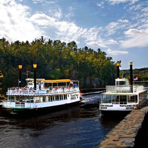 a boat traveling along a river next to a body of water