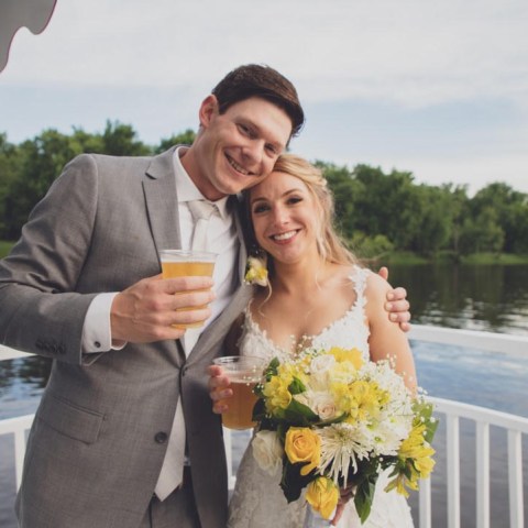 a man and a woman standing in front of water