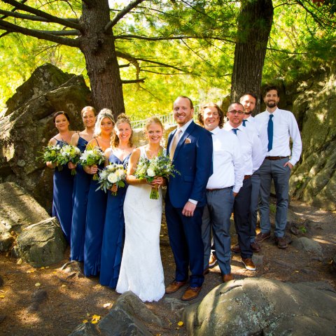 a group of people standing next to a tree