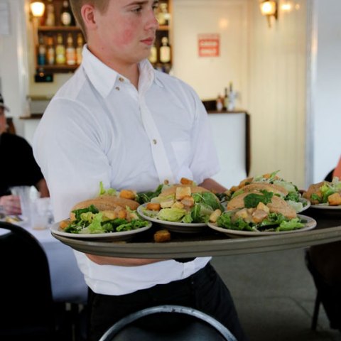 a man sitting at a table with a plate of food