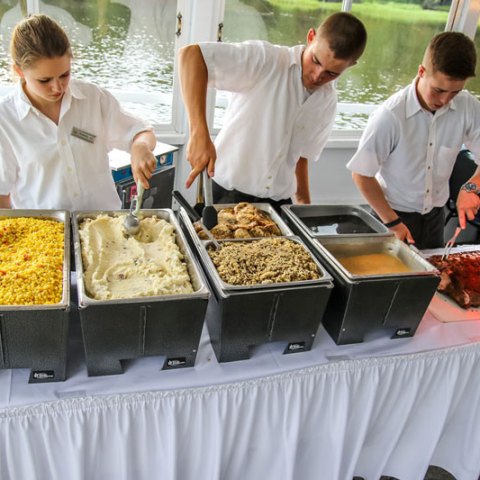 a group of people preparing food on a table