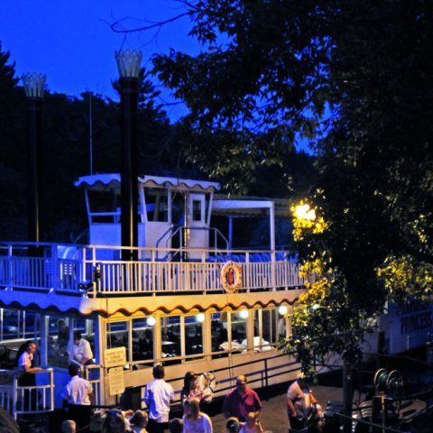 a group of people standing around a bus