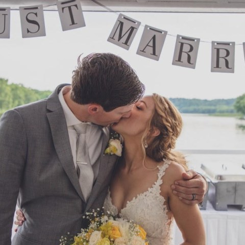 a man and a woman standing in front of a river