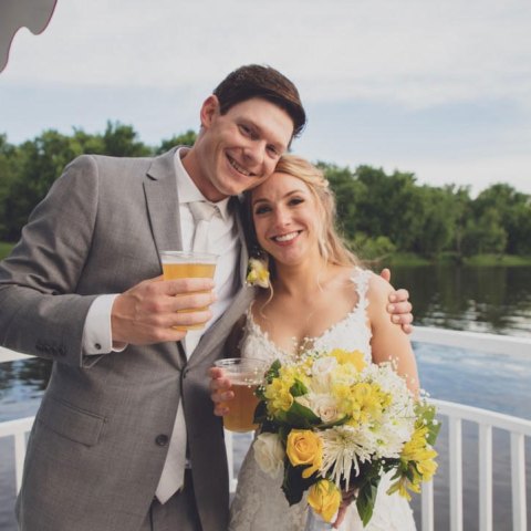 a man and a woman standing in front of water