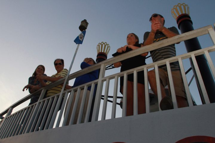 a group of people sitting on top of a building
