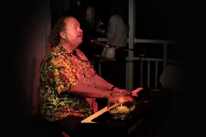 a person sitting at a table in a dark room