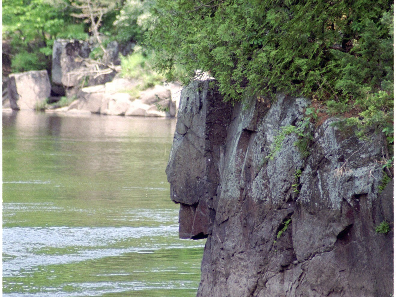 Rock formation like lions head next to water