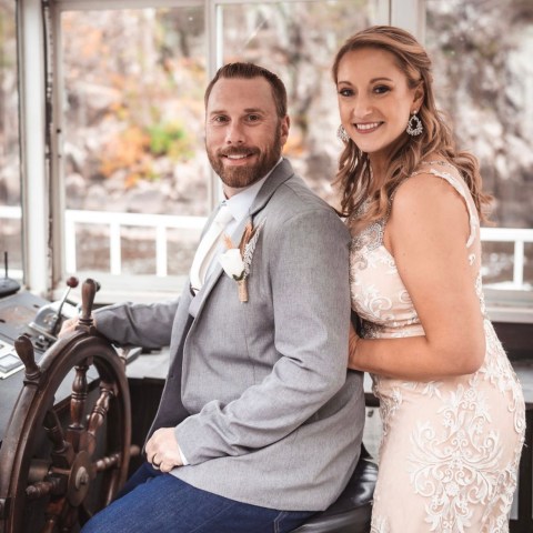 a man and a woman standing in front of a window