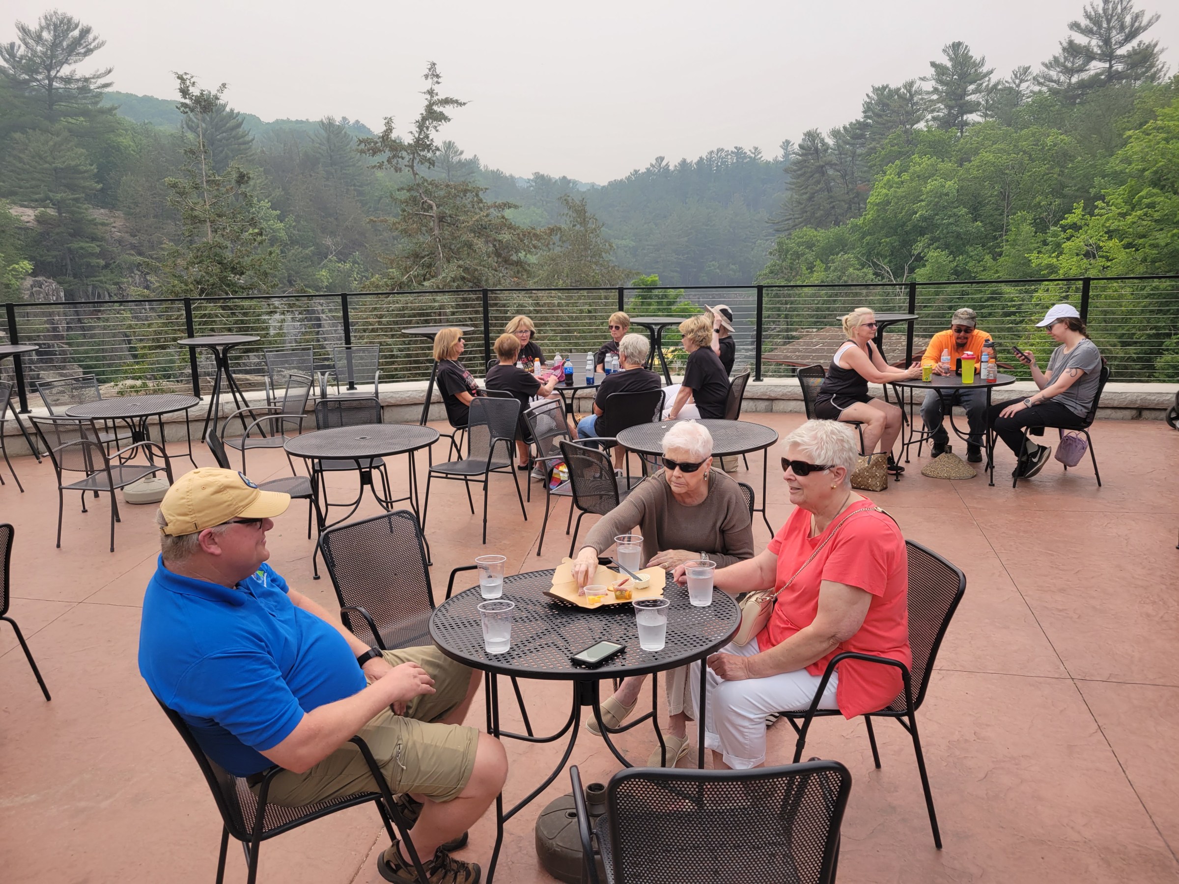 a group of people sitting at a picnic table