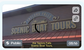 Sign reads 'Scenic Boat Tours' on a building with a red roof.